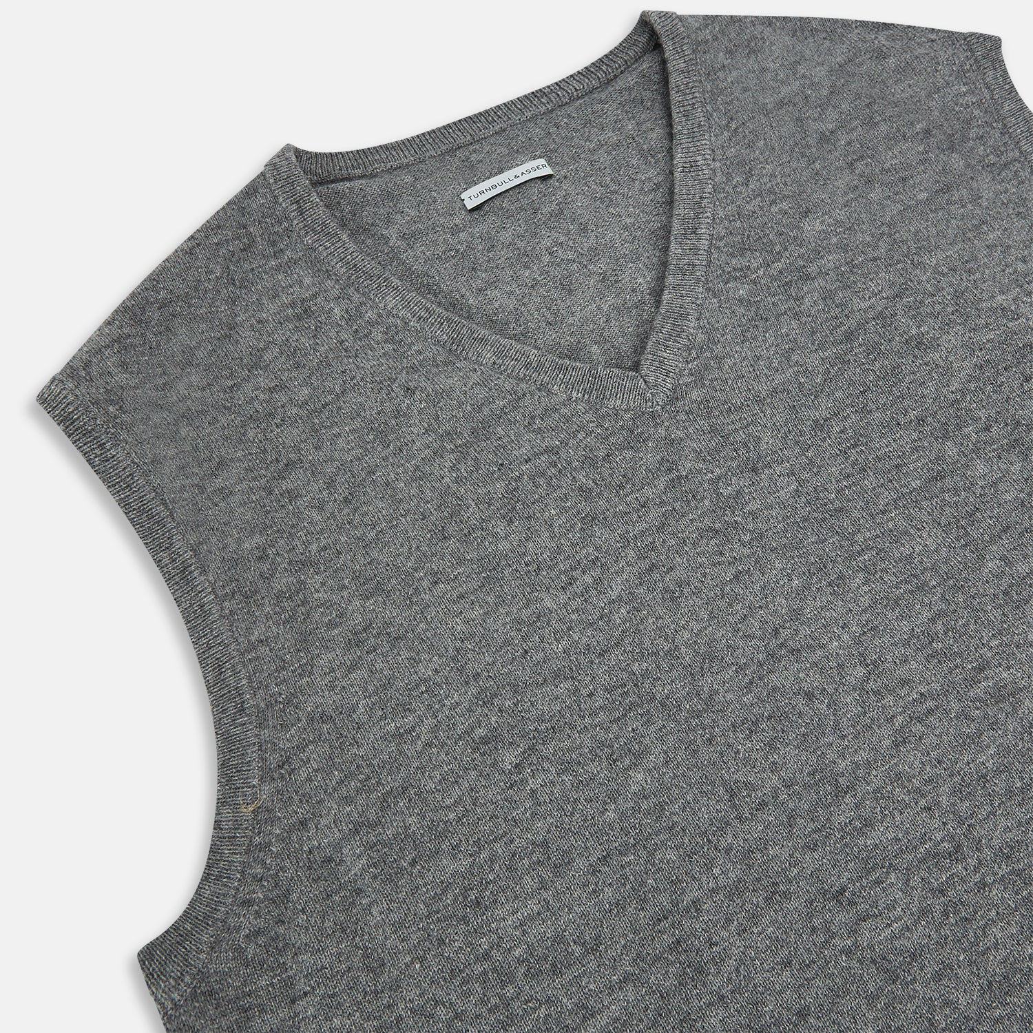 View 2 of product Turnbull & Asser's Grey Melange V-neck Cashmere Vest features classic ribbed trim at the neck, armholes, and hem—an elegant addition to any gentleman’s wardrobe, shown here against a plain white background.