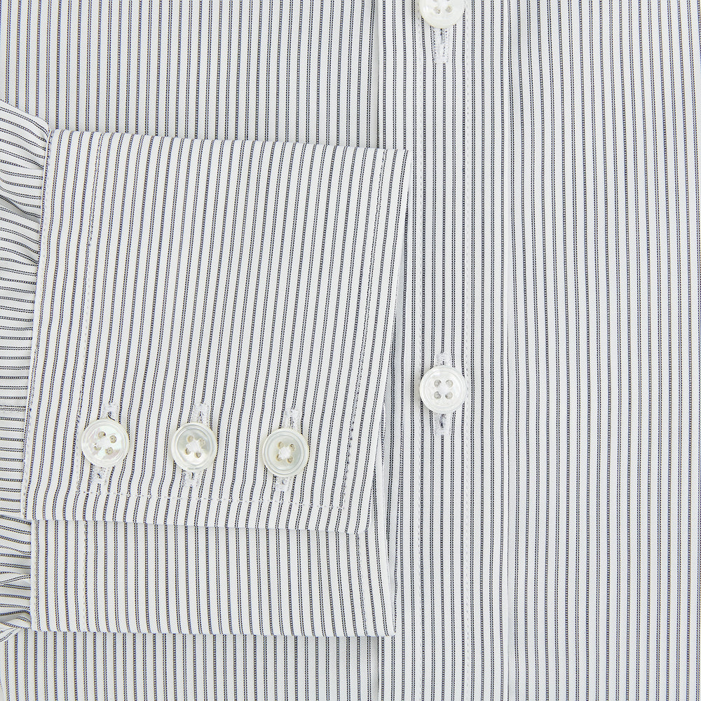 A long-sleeved Midnight Blue Fine Track Stripe Mayfair Shirt by Turnbull & Asser, featuring a T&A collar and white buttons, is laid neatly flat on a white background.