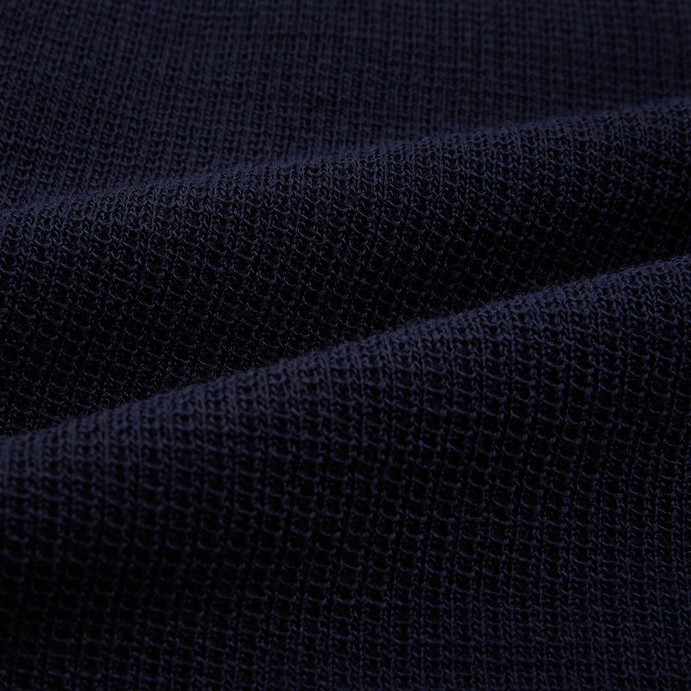 The Turnbull & Asser Navy Greenwich Knitted Overshirt, made from Italian wool with a collar, two front flap pockets, and a hidden button placket, is shown laid flat on a white background.