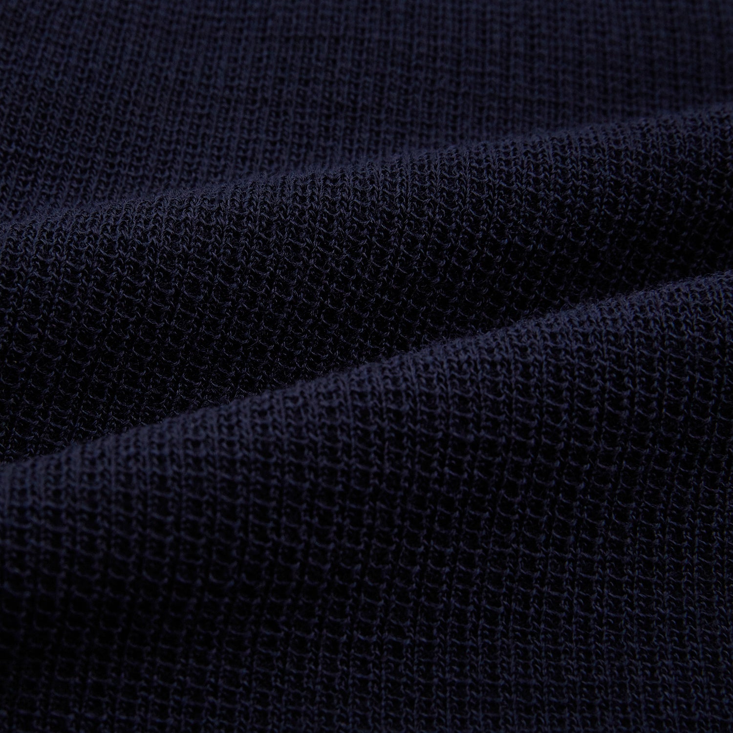 View 6 of product The Turnbull & Asser Navy Greenwich Knitted Overshirt, made from Italian wool with a collar, two front flap pockets, and a hidden button placket, is shown laid flat on a white background.