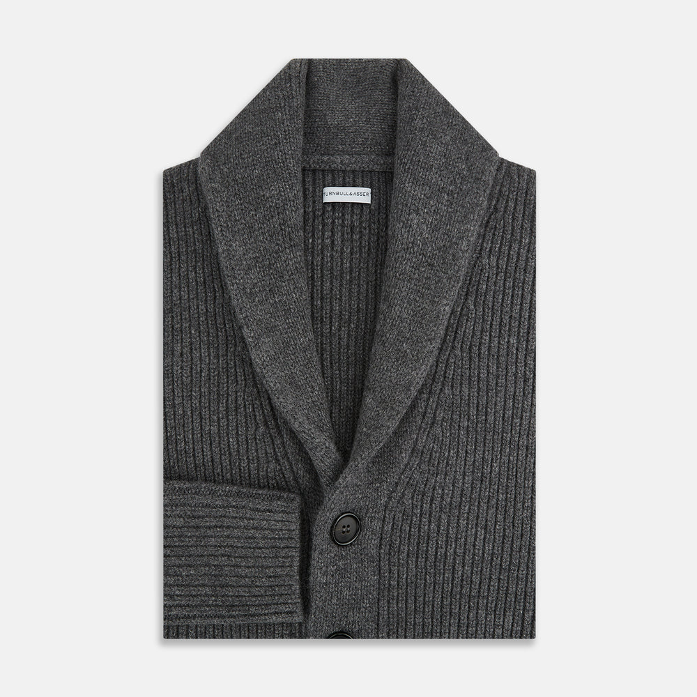 The Turnbull & Asser Shadow Grey Cashmere Shawl Collar Cardigan features ribbed detailing, a front button closure, and two front pockets, shown against a plain white background.