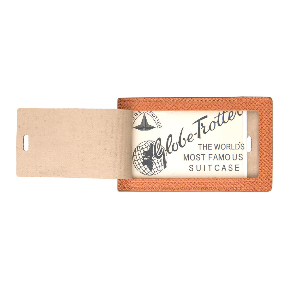 The Brown Leather Luggage Tag by Turnbull & Asser features textured brown leather, a silver buckle strap, and the Turnbull & Asser name embossed in silver at the bottom.