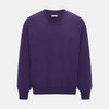 View 1 of product The Turnbull & Asser Purple Cashmere Round Neck Jumper features long sleeves, ribbed cuffs, hem, and collar for an elegant silhouette. This versatile knitwear piece is shown against a white background.