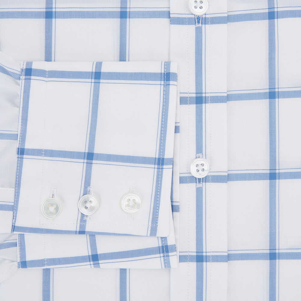 The Turnbull & Asser Colony Blue Grid Check Mayfair Shirt features long sleeves, a button-down front, Italian cotton fabric, a spread collar, and buttoned cuffs, shown against a plain white background.