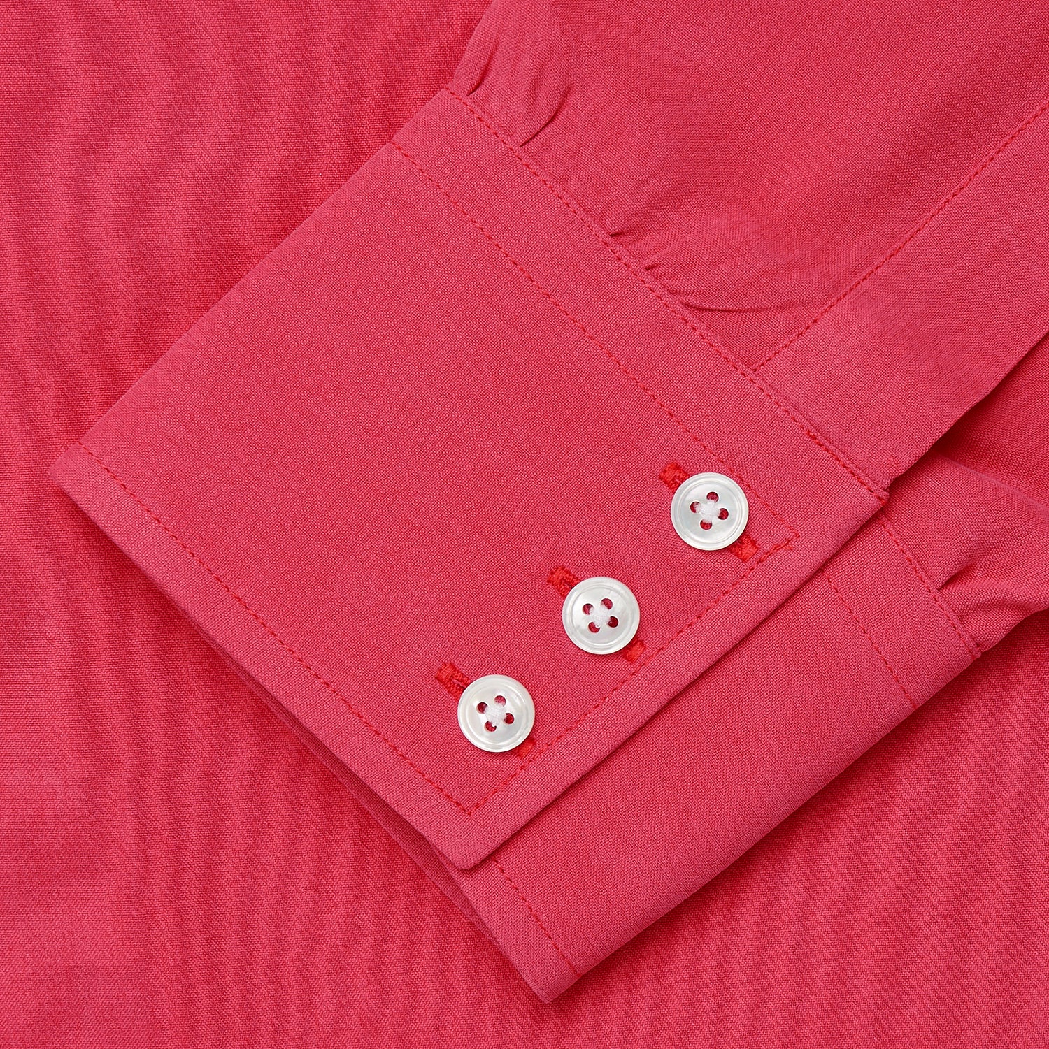View 4 of product The Turnbull & Asser Coral Pink Silk Regular Fit Mayfair Shirt features long sleeves, a classic collar, and white buttons, displayed laid flat on a plain white background.