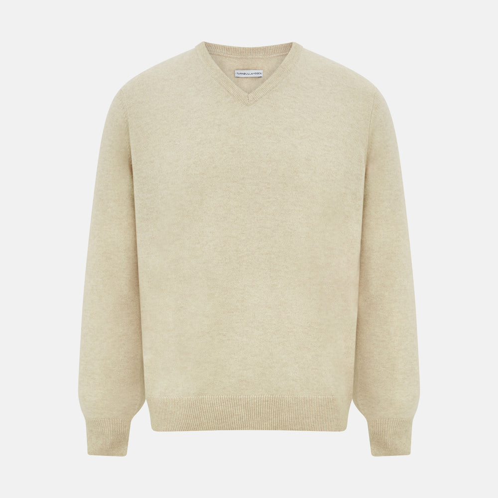 The Turnbull & Asser Ivory Cashmere V-Neck Jumper, with long sleeves and ribbed cuffs and hem, is shown against a plain white background.