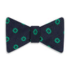View 1 of product The Navy and Green Motif Silk Bow Tie by Turnbull & Asser features geometric floral patterns, ideal for formalwear, and is shown on a white background.