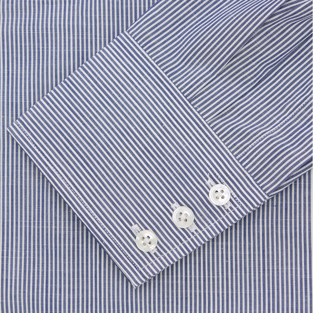 The Turnbull & Asser Navy and White Bengal Stripe Tailored Fit Shirt features blue and white vertical stripes, white buttons, and a streamlined silhouette, shown neatly folded against a plain white background.