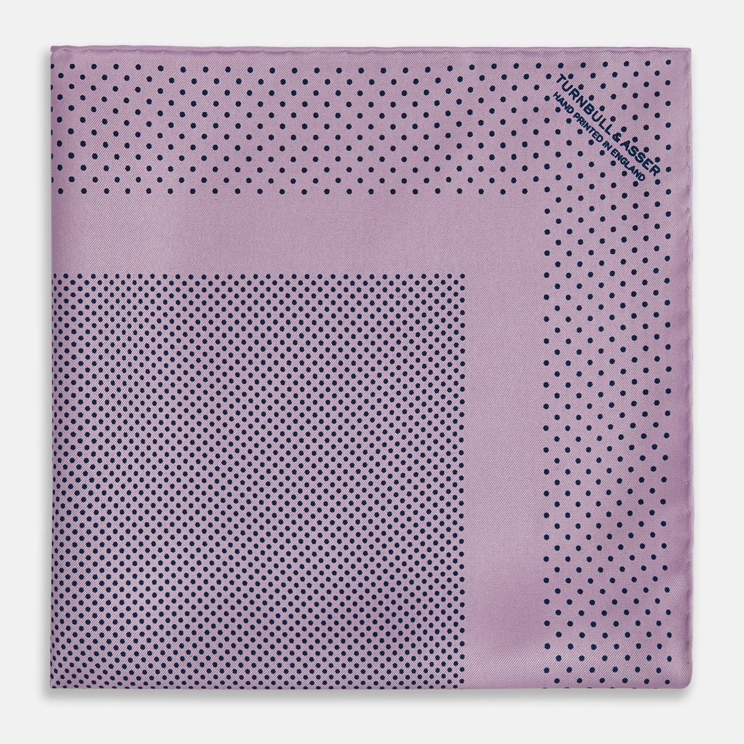 View 3 of product The Lilac Dot Silk Pocket Square by Turnbull & Asser is handmade from silk in a folded design, featuring small black polka dots and a solid border.