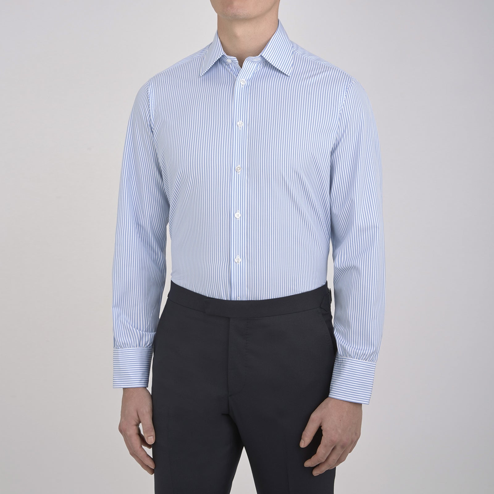 View 5 of product The Turnbull & Asser Light Blue Bengal Stripe Shirt features a classic T&A collar and 3-button cuffs, showcasing subtle British style in crisp white pinstripes, shown laid flat on a white background.