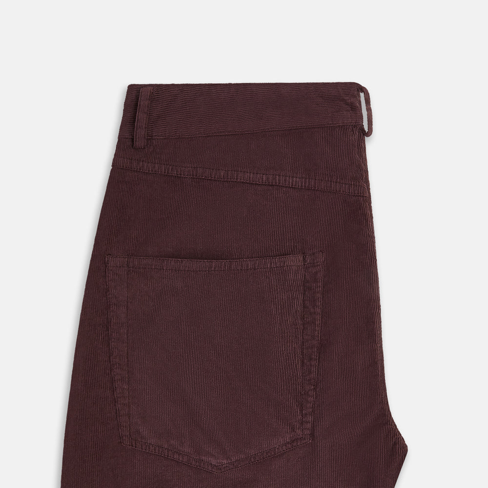 The Turnbull & Asser Burgundy Corduroy Charles Trousers are straight-leg stretch cotton pants in dark burgundy, featuring side and back pockets, shown against a plain white background.