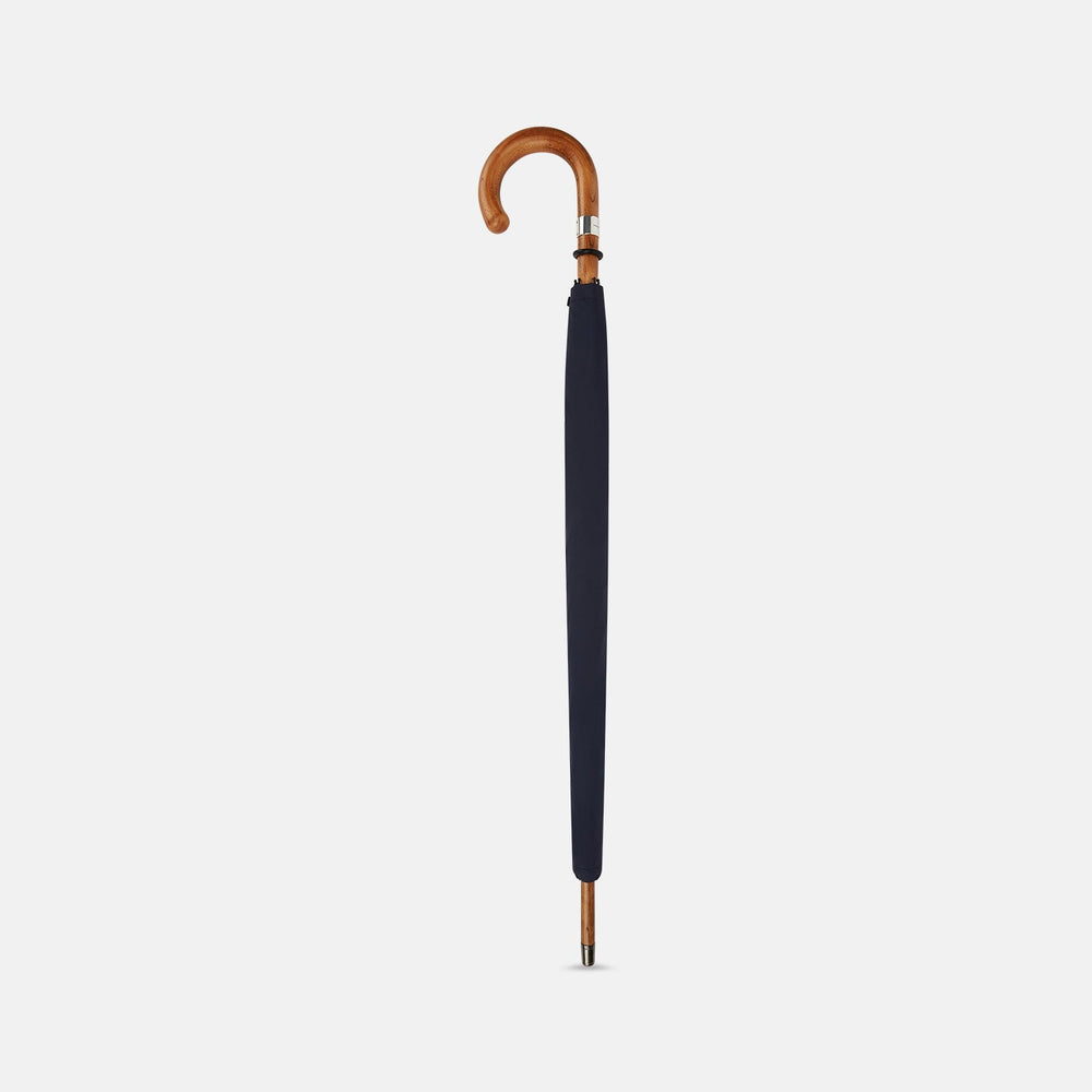 The Turnbull & Asser Navy Umbrella with Maple Crook Handle is open against a white background—an elegant men's accessory inspired by classic style.