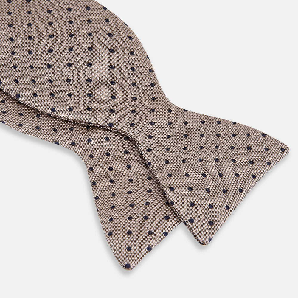 The Turnbull & Asser Navy and Taupe Micro Dot Silk Bow Tie features a grid pattern with small dots, shown against a plain white background.