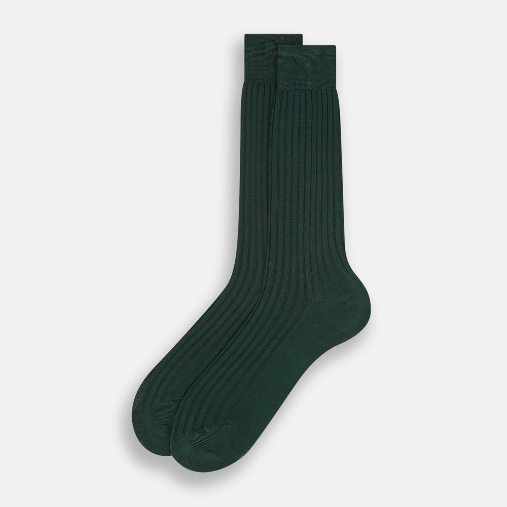 Turnbull & Asser's Olive Mid-Length Socks, crafted from mercerised Egyptian cotton in dark green with ribbed detailing, are displayed against a plain white background, showcasing refined comfort and enduring style.