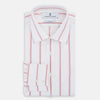View 5 of product The Turnbull & Asser Coral Track Stripe Mayfair Shirt features a white Italian cotton fabric with vertical red stripes and a pointed T&A collar, shown against a plain light background.