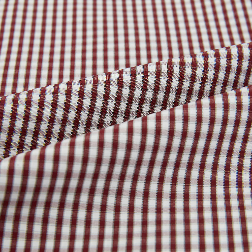 The Turnbull & Asser Burgundy Micro Check Winston Long Nightshirt is knee-length with long sleeves, brown and white micro checks, a collar, chest pocket with piping, and a front button placket.