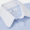 View 4 of product The Turnbull & Asser Micro Blue Check with White Collar and Cuff Shirt, a light blue long-sleeve style, features contrasting white collar and cuffs, buttoned down the front and laid flat on a white background.
