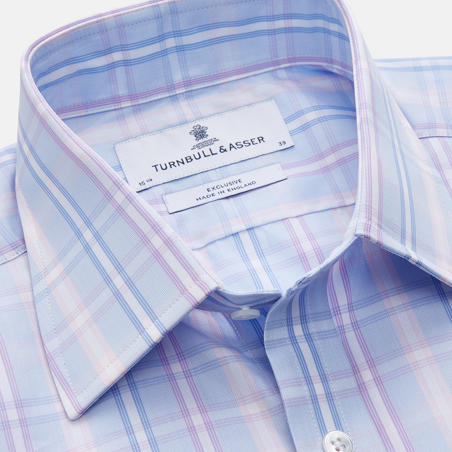 View 4 of product The Turnbull & Asser Pink and Light Blue Check Cotton Regular Fit Mayfair Shirt features long sleeves, buttoned cuffs, a T&A collar, and is shown laid flat on a white background.