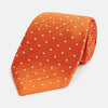 View 1 of product The Turnbull & Asser Orange and White Micro Dot Silk Tie features a subtle herringbone weave with small white dots—an elegant, modern accessory for the office.