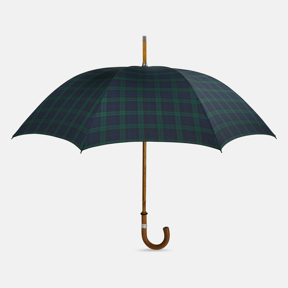 The Turnbull & Asser Black Watch Tartan Traveller Umbrella features a Malacca crook handle and a dark green and navy blue plaid canopy, shown against a plain white background.