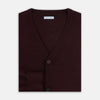 View 4 of product The Turnbull & Asser Burgundy Fine Merino V-Neck Cardigan features long sleeves and a button-down front, highlighting elegant handcrafted knitwear against a plain white background.