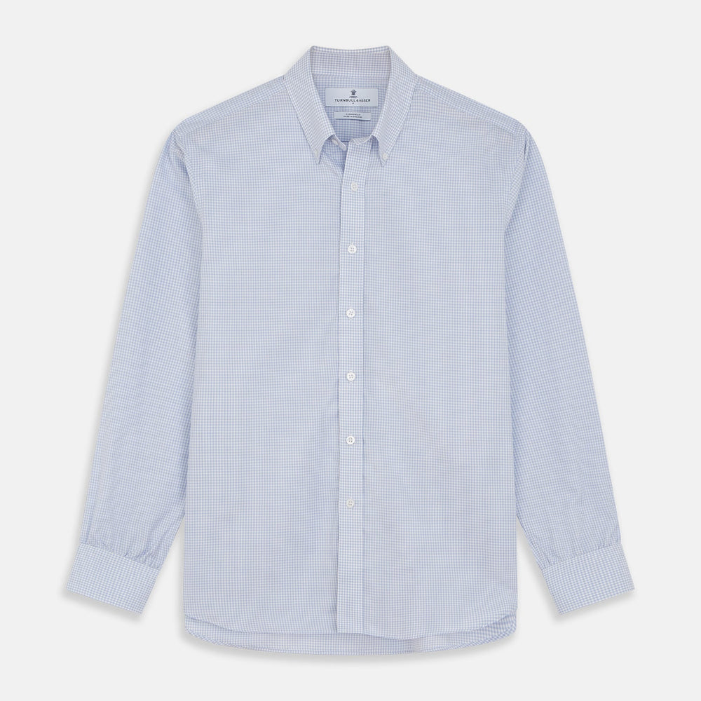 A close-up of Turnbull & Asser’s Pale Blue Multi Check Cashmerello Fabric, featuring a small light blue and white check pattern, shown within a circular frame against a plain white background.