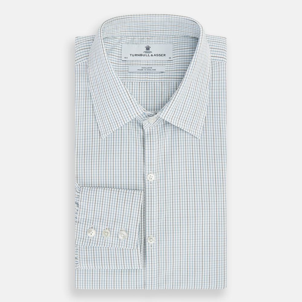 The Pale Blue and Navy Grid Check Westminster Shirt by Turnbull & Asser features a button-down front and pointed collar, highlighting fine British craftsmanship, displayed on a white background.