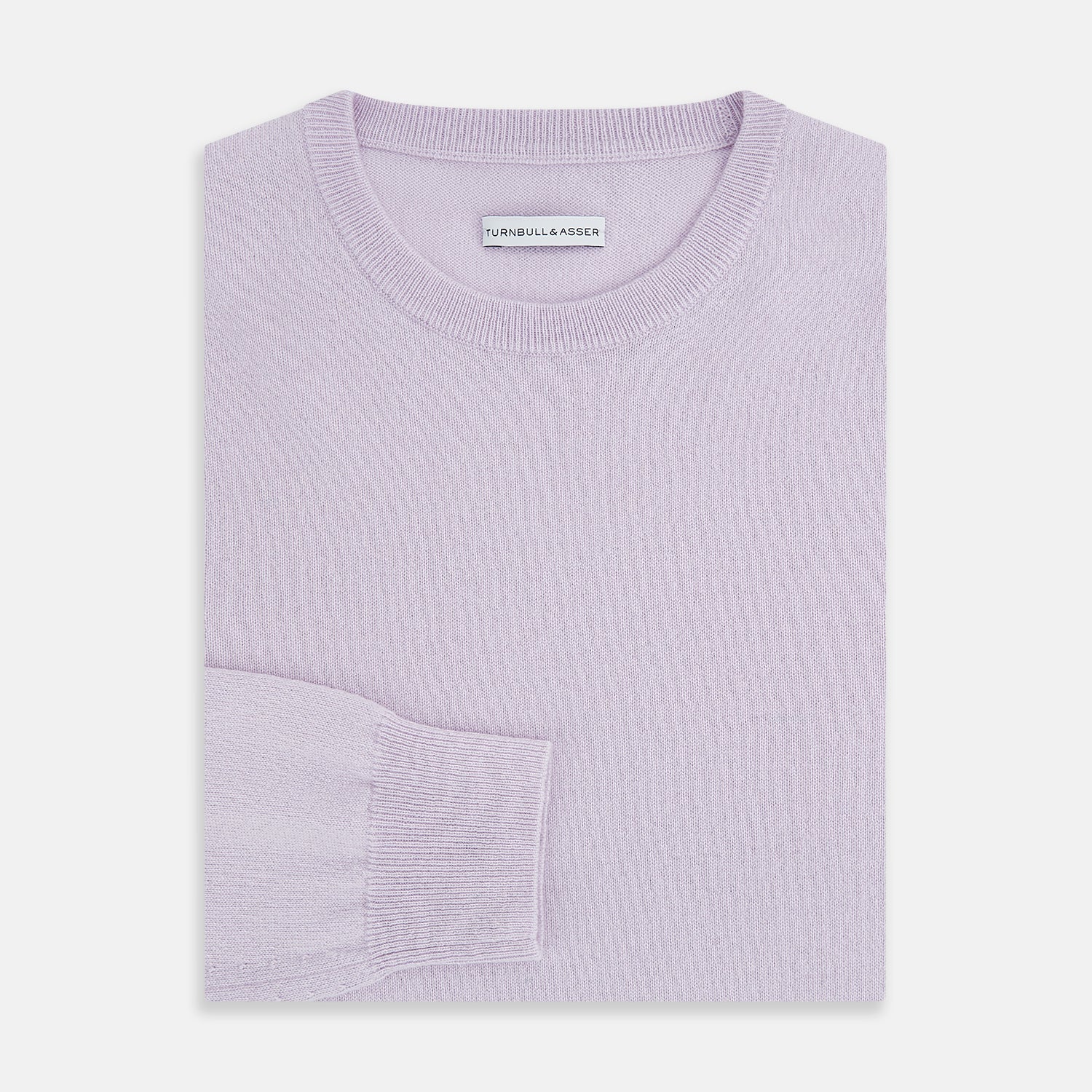 View 7 of product The Turnbull & Asser Lilac Cashmere Round Neck Jumper for men features long sleeves with ribbed cuffs and hem, offering a stylish, refined look. Shown against a white background.