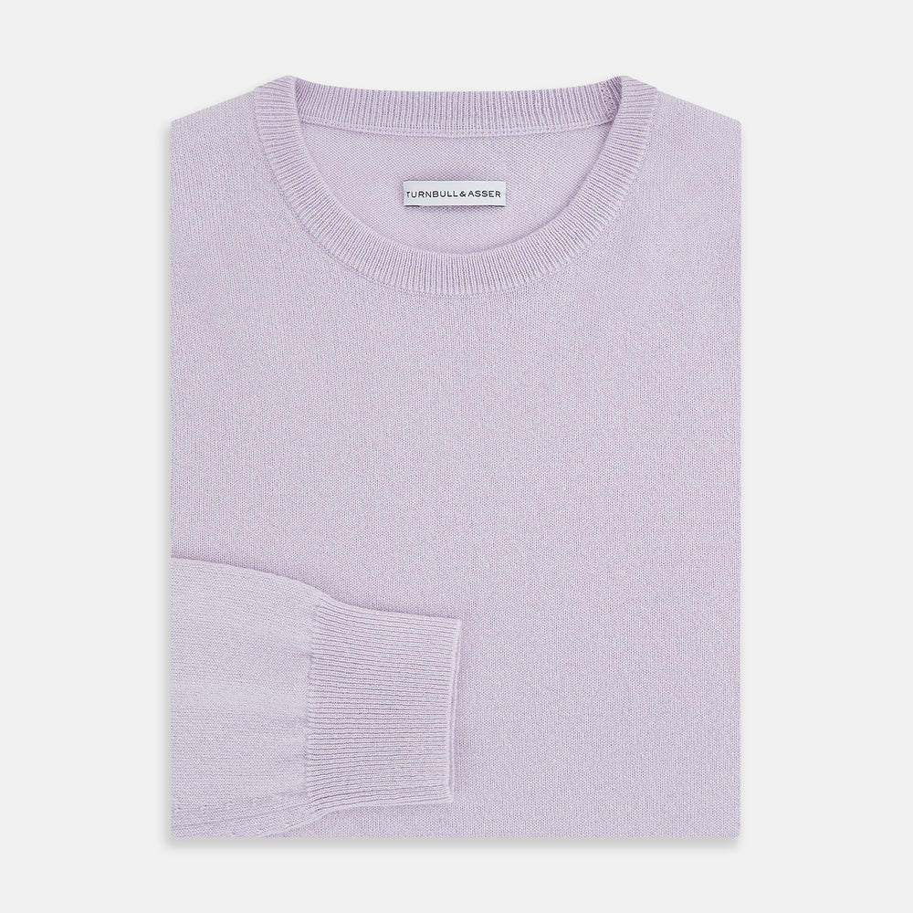 The Turnbull & Asser Lilac Cashmere Round Neck Jumper for men features long sleeves with ribbed cuffs and hem, offering a stylish, refined look. Shown against a white background.