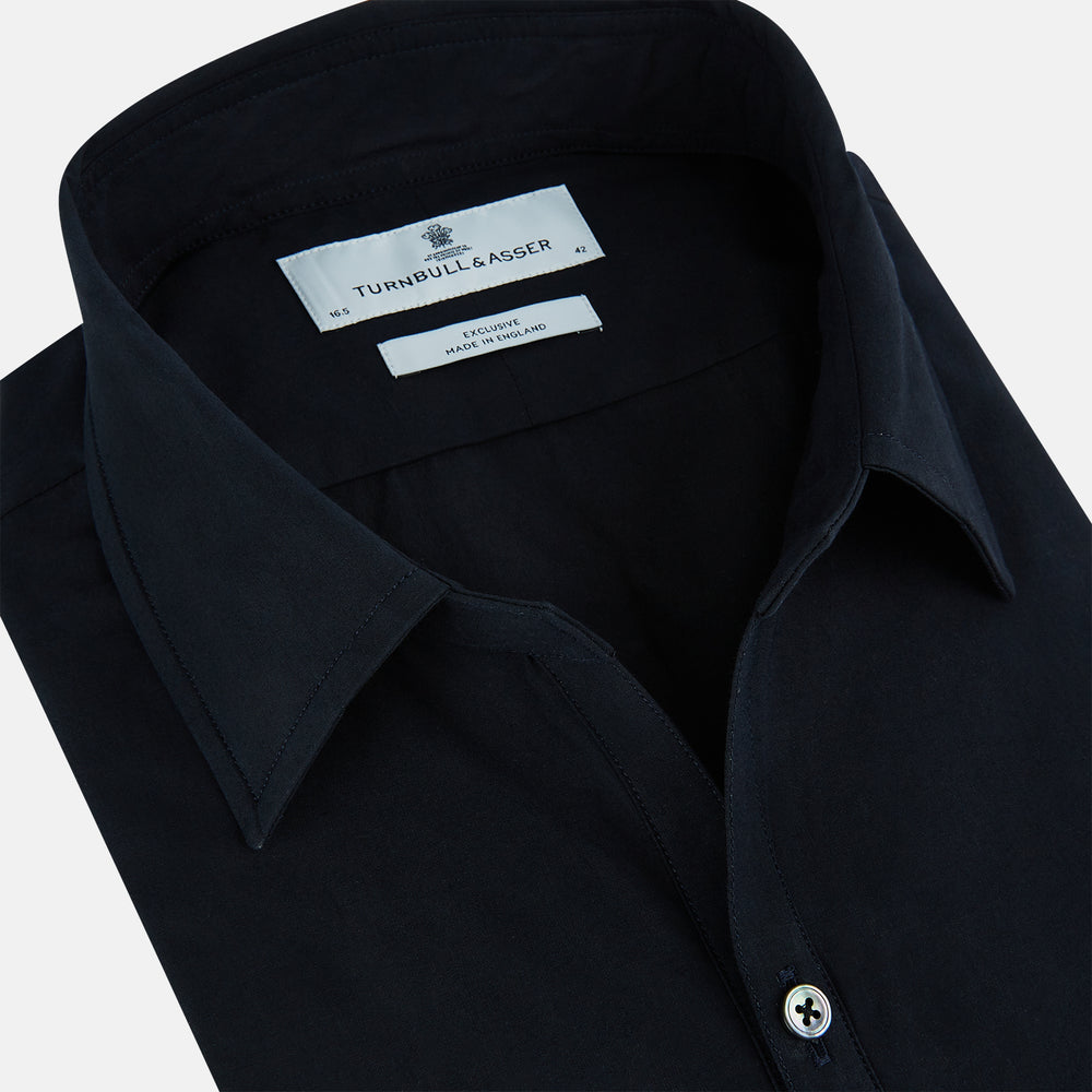 The DARK NAVY WINDSOR SHIRT by Turnbull & Asser is a long-sleeve shirt with a refined Windsor collar, showcasing classic British craftsmanship.