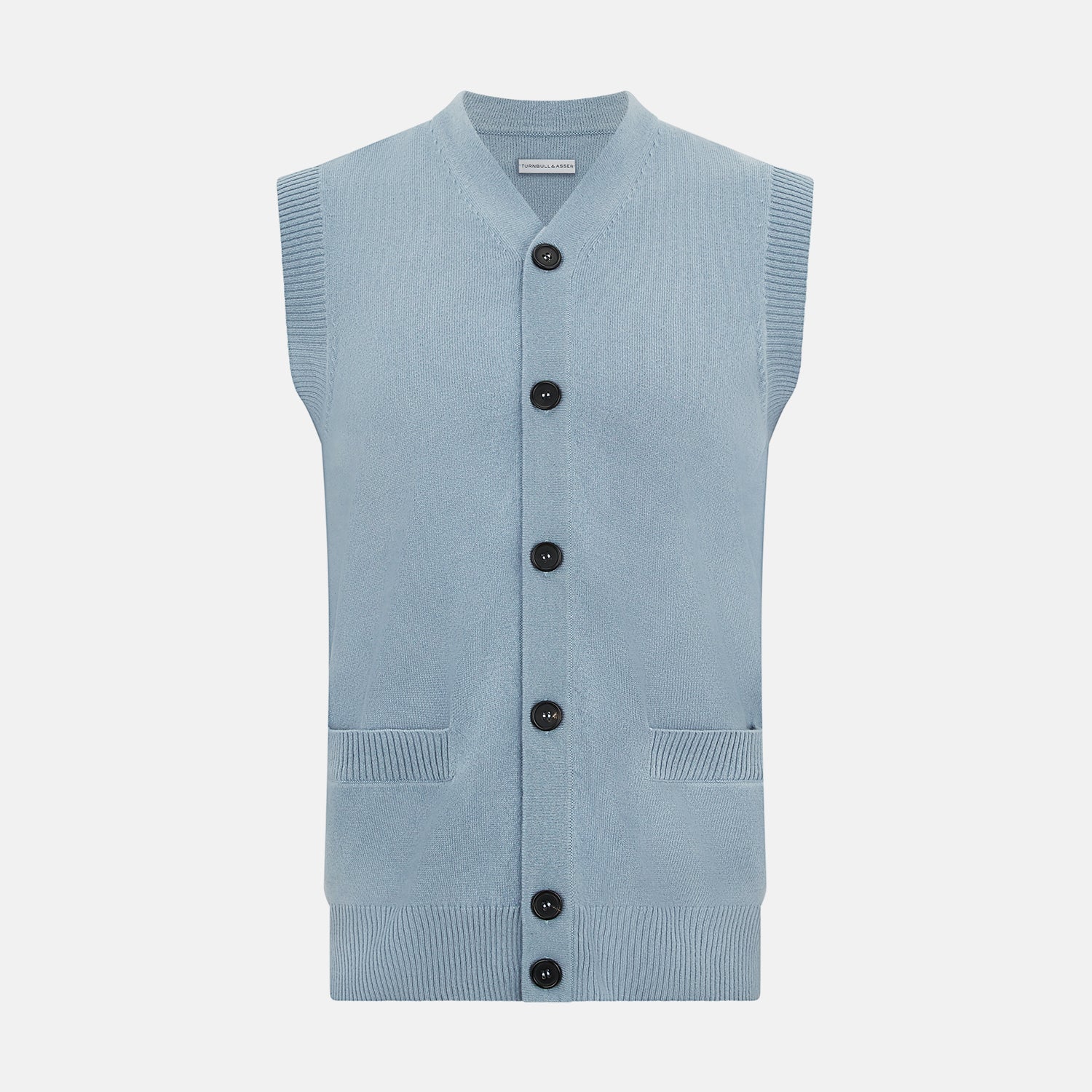 View 1 of product The Turnbull & Asser Frost Blue Cashmere Sleeveless Cardigan features a V-neck, five black buttons, two front pockets, and ribbed trim—ideal for layering in sophisticated outfits.