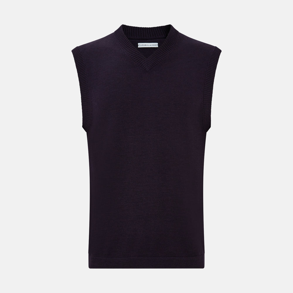 The Turnbull & Asser Dark Purple Fine Merino V-Neck Vest features ribbed edges and a sleeveless design, ideal for a gentleman’s style in cooler seasons, and is displayed on a plain white background.