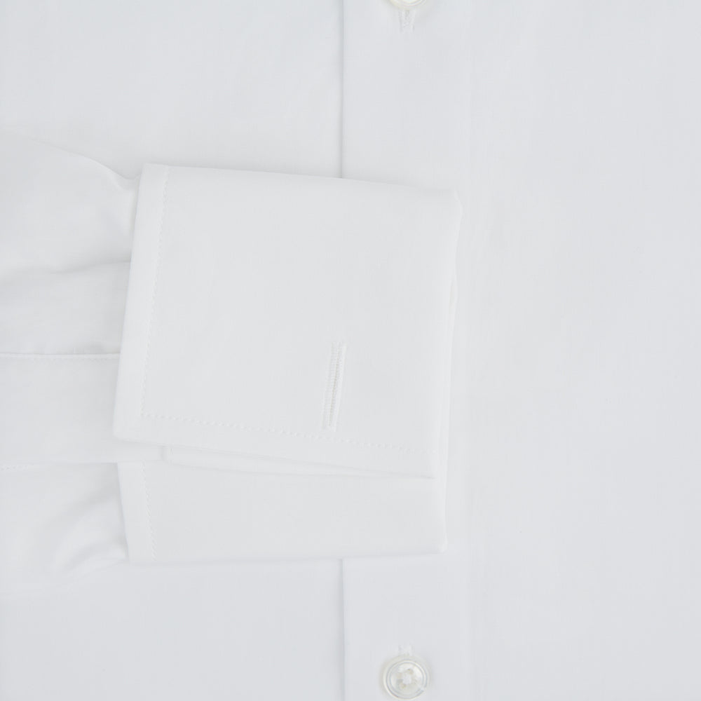 The Turnbull & Asser Tailored Fit Plain White Cotton Shirt features a Kent collar, button-down front, long sleeves, and double cuffs, shown on a white background.