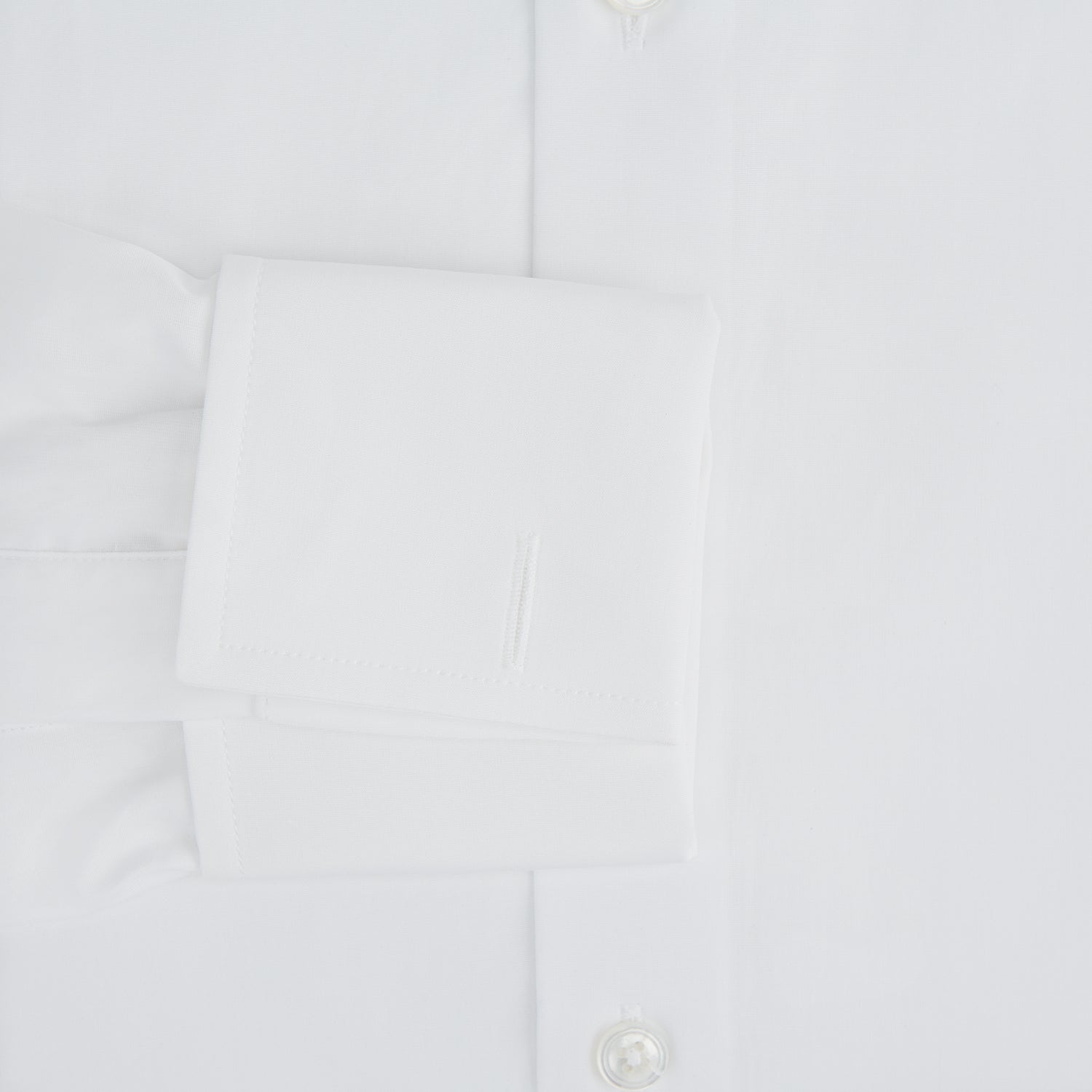 View 3 of product The Turnbull & Asser Tailored Fit Plain White Cotton Shirt features a Kent collar, button-down front, long sleeves, and double cuffs, shown on a white background.