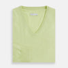 View 4 of product The Turnbull & Asser Pistachio Cashmere V-neck Jumper features long sleeves, ribbed cuffs and hem. Shown in light green against a white background, it's a classic addition to any knitwear collection.