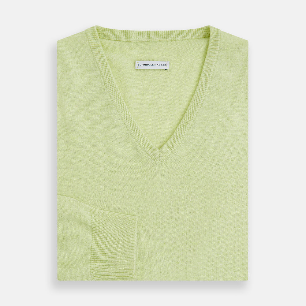 The Turnbull & Asser Pistachio Cashmere V-neck Jumper features long sleeves, ribbed cuffs and hem. Shown in light green against a white background, it's a classic addition to any knitwear collection.