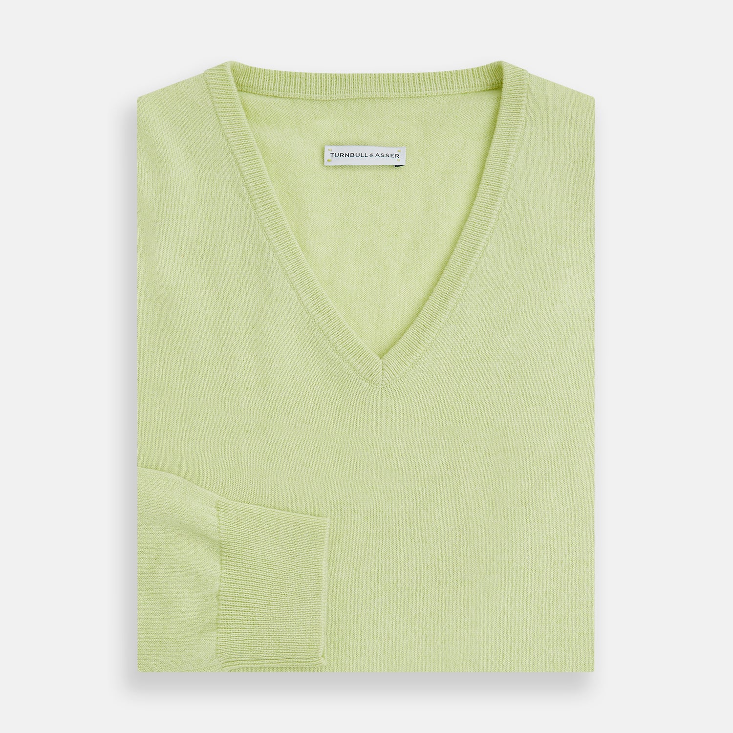 View 4 of product The Turnbull & Asser Pistachio Cashmere V-neck Jumper features long sleeves, ribbed cuffs and hem. Shown in light green against a white background, it's a classic addition to any knitwear collection.