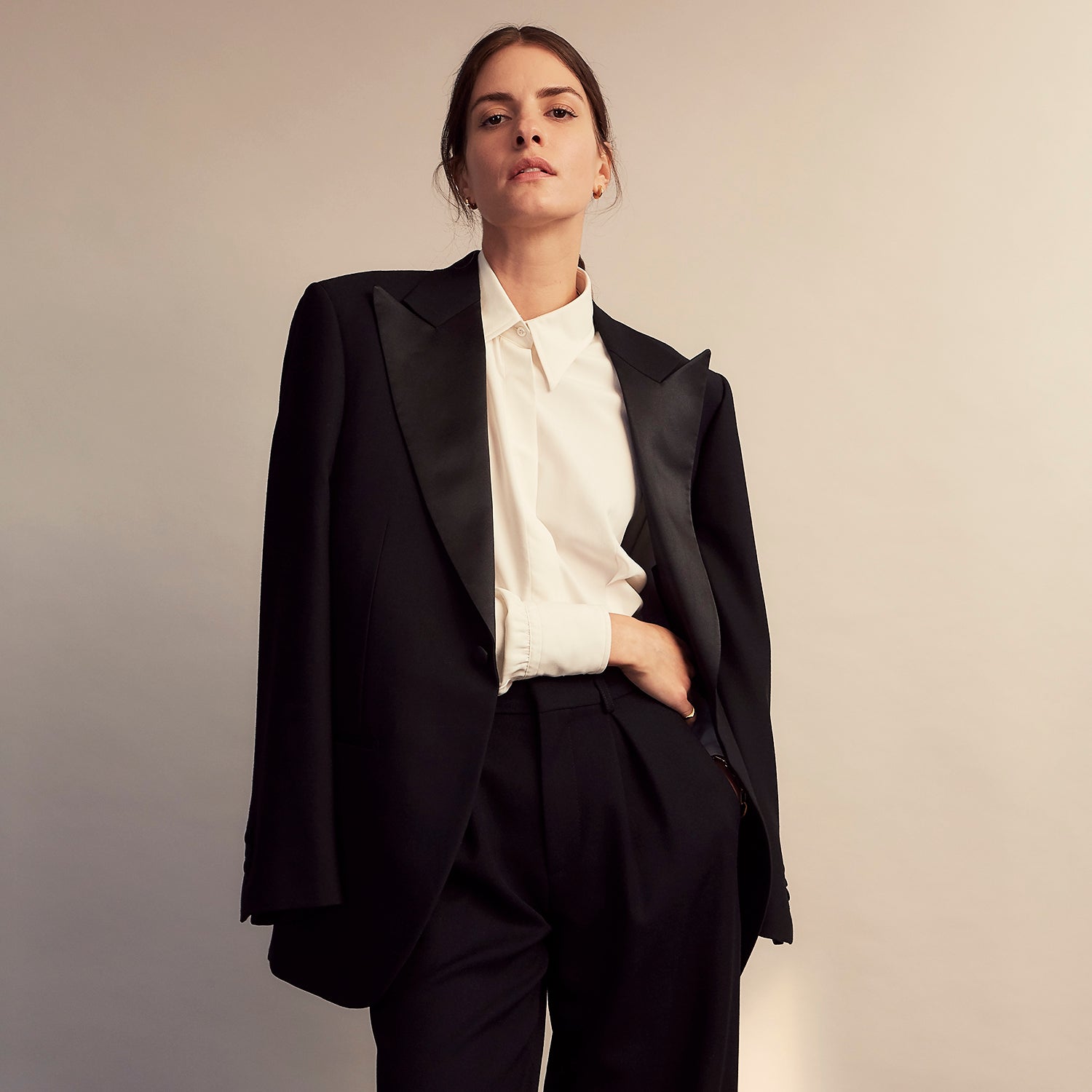 View 12 of product The Cream Silk Tailored Bianca Shirt by Turnbull & Asser features long sleeves, a pointed collar, and curved hem in soft-touch peace silk with a tailored fit. Shown laid flat on a white background.