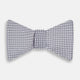 The Turnbull & Asser Silver and White Square Silk Bow Tie features a subtle geometric pattern, ideal for formalwear, and is displayed against a plain white background.