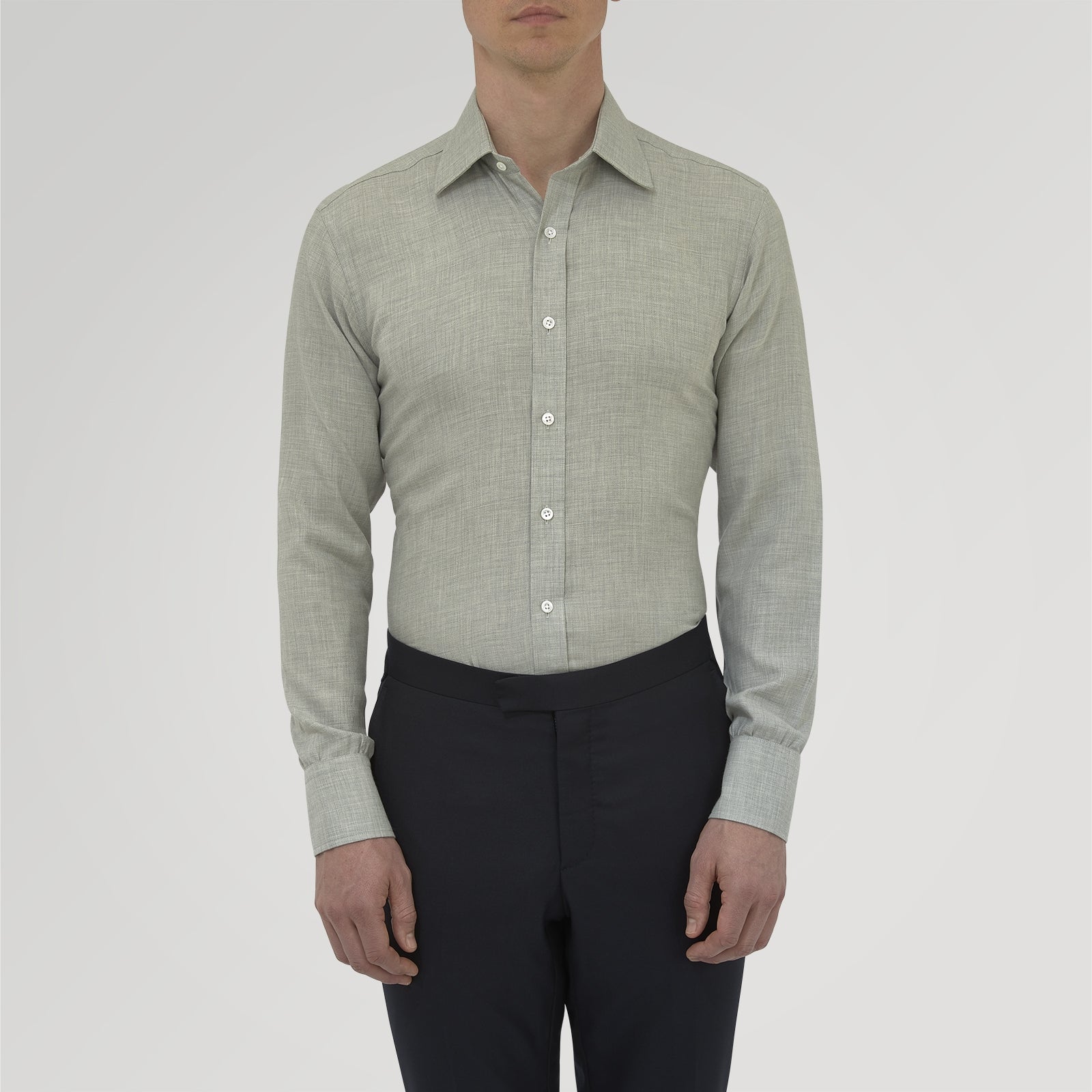 View 2 of product The Turnbull & Asser Grey Cashmere Blend Shirt features a T&A collar, 3-button cuffs, and a front pocket, shown neatly folded with white buttons against a plain white background.