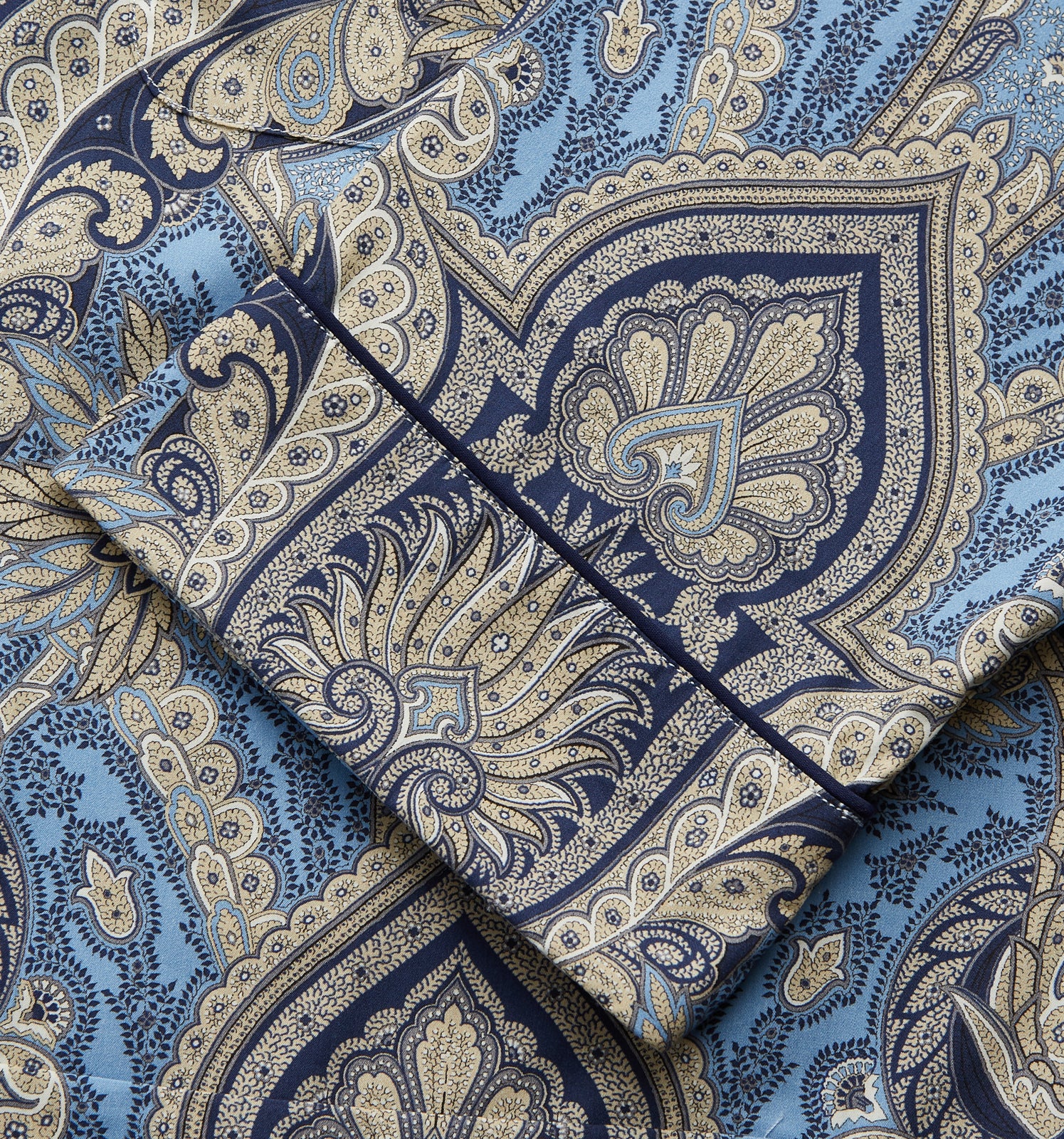 View 4 of product The Turnbull & Asser Pale Blue Baroque Silk-blend Hyde Pyjama Set features a long-sleeve button-up shirt and pants in a blue and beige paisley pattern, shown flat on a white background.