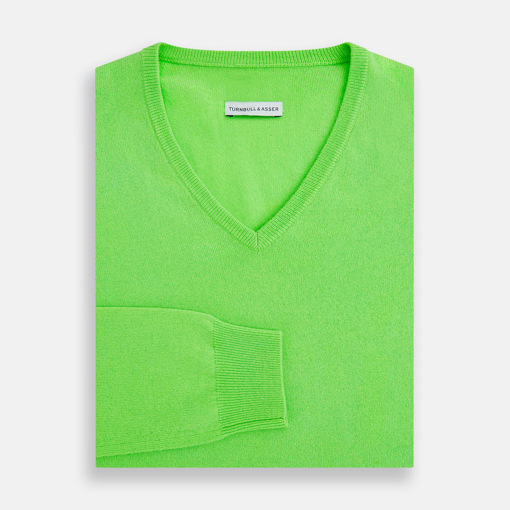 The Turnbull & Asser Bright Green Cashmere V-Neck Jumper features long sleeves with ribbed cuffs and hem—a vibrant addition to your knitwear collection, shown on a plain white background.