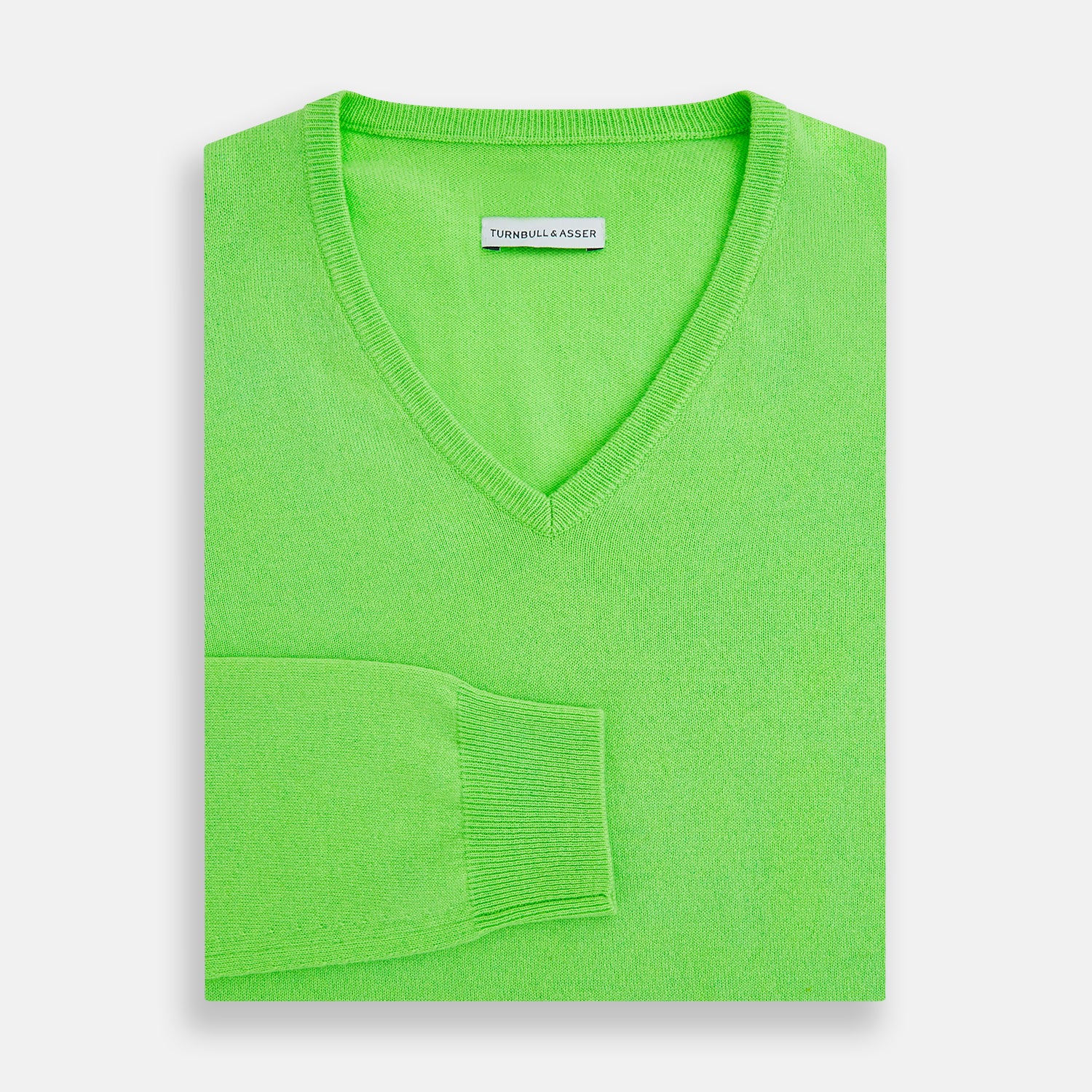View 4 of product The Turnbull & Asser Bright Green Cashmere V-Neck Jumper features long sleeves with ribbed cuffs and hem—a vibrant addition to your knitwear collection, shown on a plain white background.