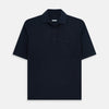 View 1 of product The Turnbull & Asser Navy Polo Shirt features short sleeves, a collar, three-button placket, and a single buttoned chest pocket, shown flat on a plain white background.
