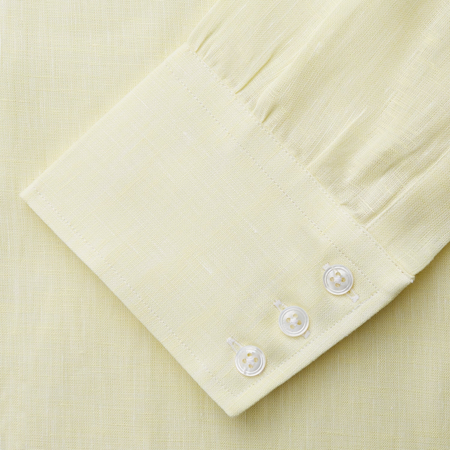 View 3 of product The Turnbull & Asser Yellow Linen Regular Fit Mayfair Shirt is a long-sleeve button-up with a collar and buttoned cuffs, shown laid flat on a white background.