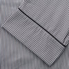 View 4 of product The Turnbull & Asser Black Candy Stripe Cotton Hyde Pyjama Set for men features soft cotton striped pajamas with a long-sleeve, button-up shirt detailed with black piping and three pockets, plus matching pants, both laid flat on a white background.