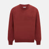 View 1 of product The Turnbull & Asser Crimson Red Cashmere Round Neck Jumper is a classic men’s knitwear piece, featuring long sleeves and a solid crimson hue, shown against a white background.