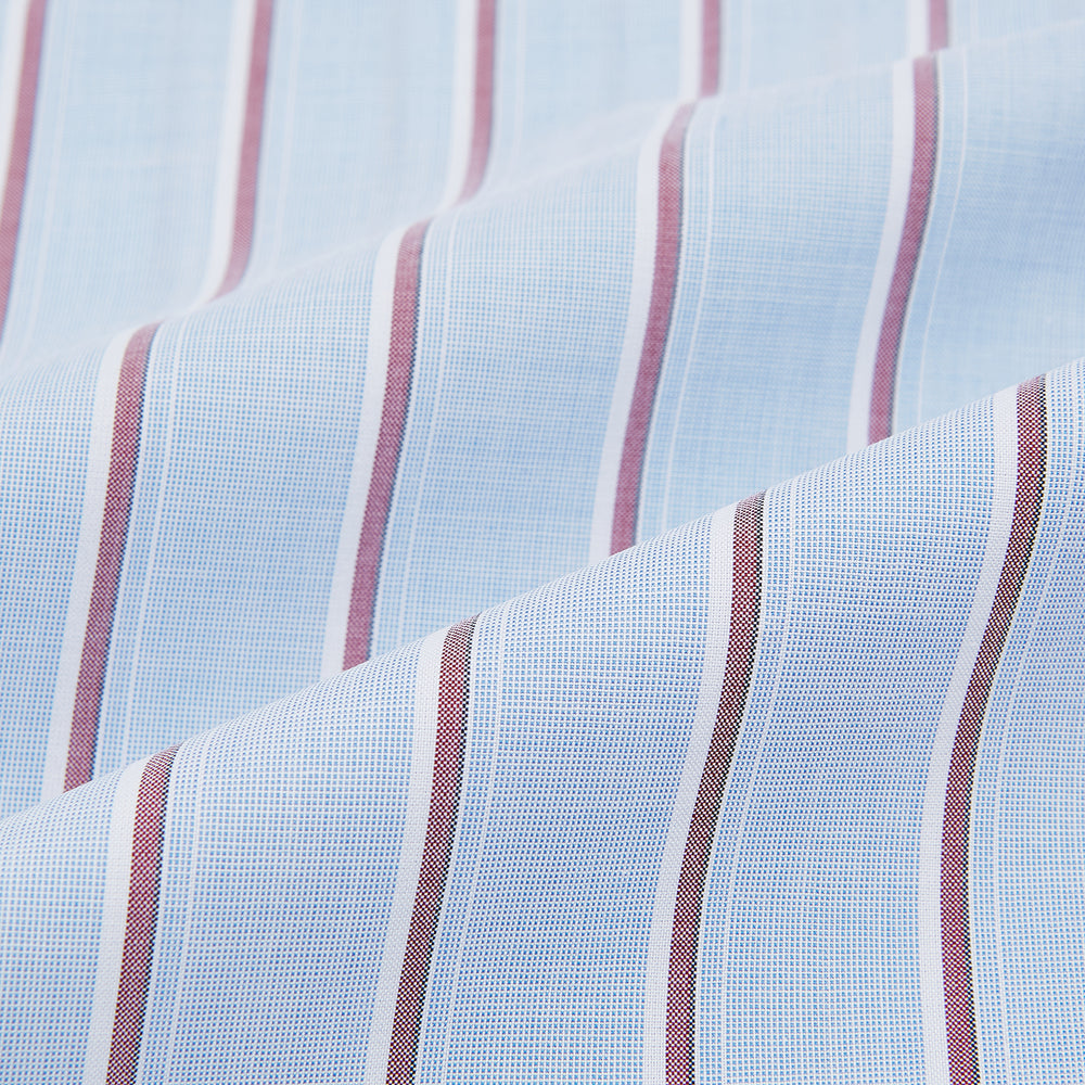 The Turnbull & Asser Blue and Burgundy Multi-Stripe Westminster Shirt features a pointed collar and long sleeves, laid flat on a white background to highlight its fine British craftsmanship.