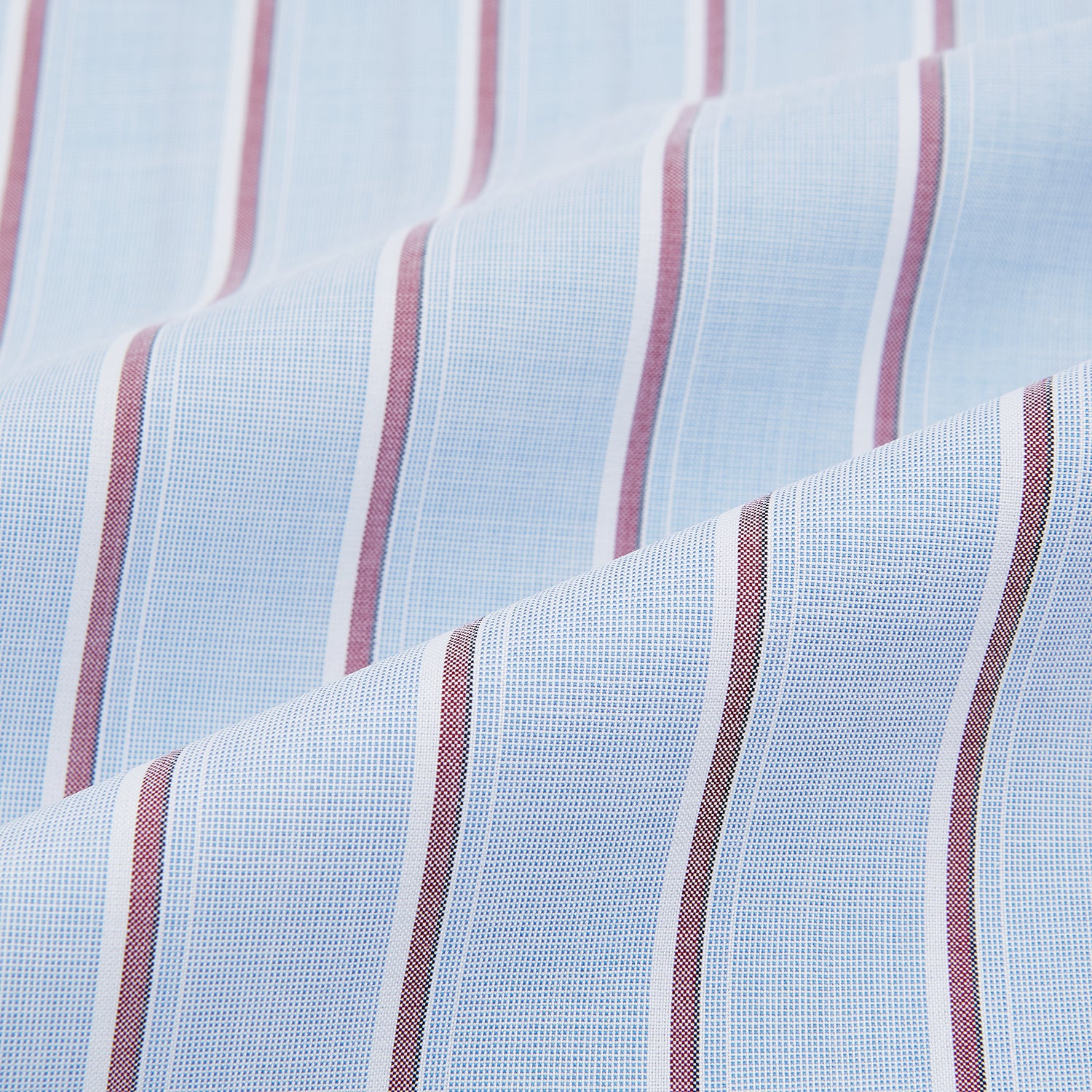 View 8 of product The Turnbull & Asser Blue and Burgundy Multi-Stripe Westminster Shirt features a pointed collar and long sleeves, laid flat on a white background to highlight its fine British craftsmanship.
