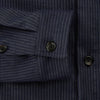 View 4 of product The Turnbull & Asser Navy Stripe Hampstead Overshirt features pinstripes, a collar, long sleeves, chest pocket, and two angled side pockets—ideal for refining your formal look. Shown laid flat on a light background.